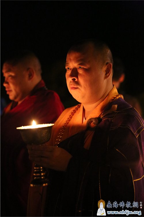 双手执灯 神情专注 摄影:顿俊
